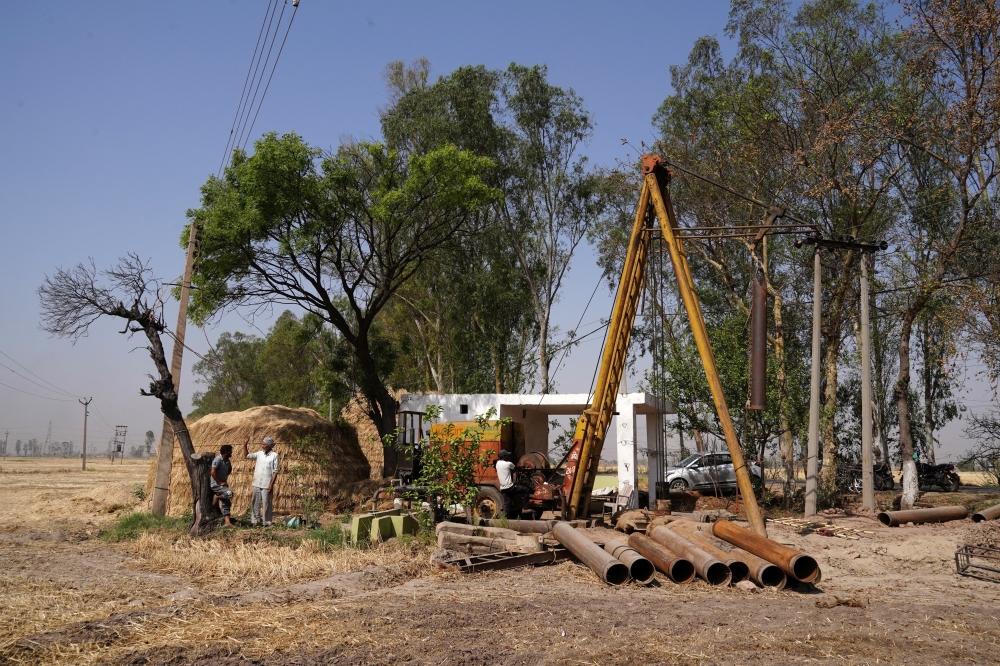 Boring machine operators install a new borewell to extract ground water in a field in Gaggarpur village in the northern state of Haryana, India, April 25, 2025. — Reuters pic