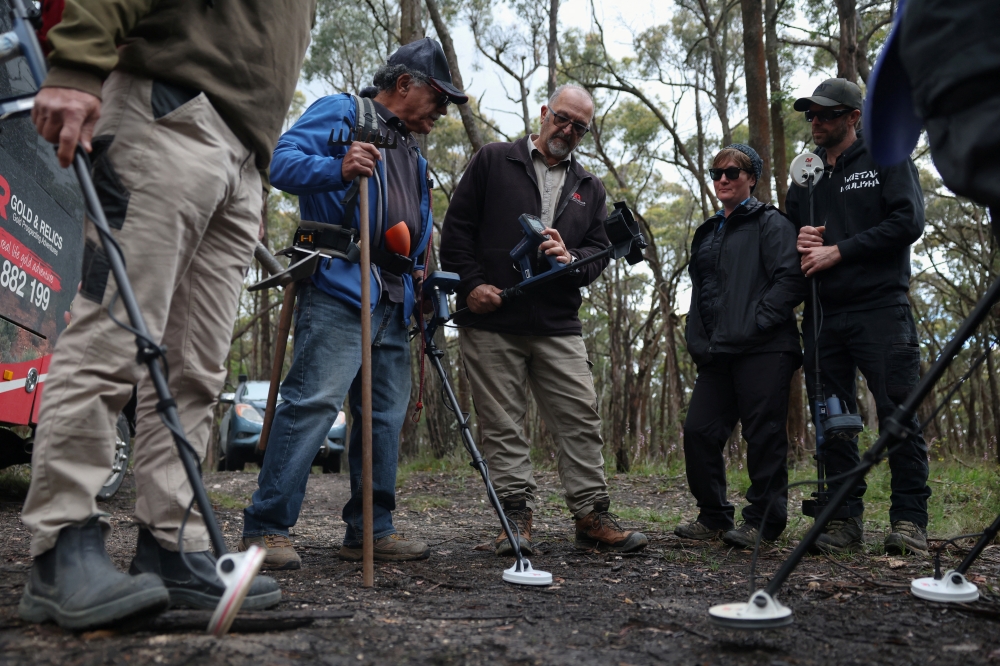 Peter Vanjek, 65, a retired maths teacher and Gold and Relics prospecting tour guide, demonstrates during a metal detector training session in Mount Doran, Australia, November 29, 2025. — Reuters pic