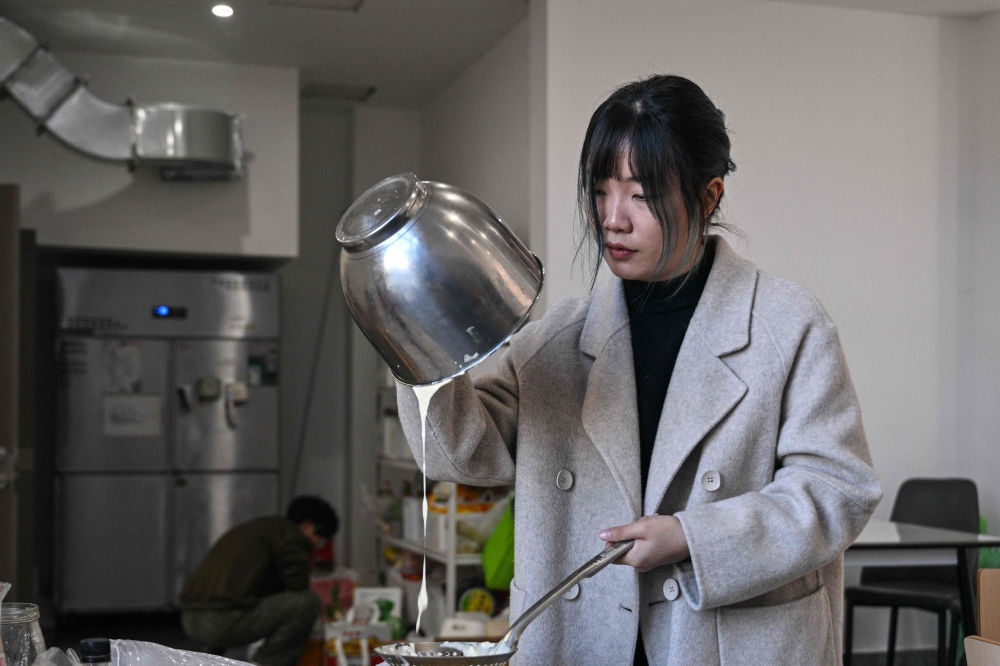 Gong Yimei, 24, formerly homeschooled student, prepares a cheesecake in Lishui, in Zhejiang province, November 26, 2025. — AFP pic