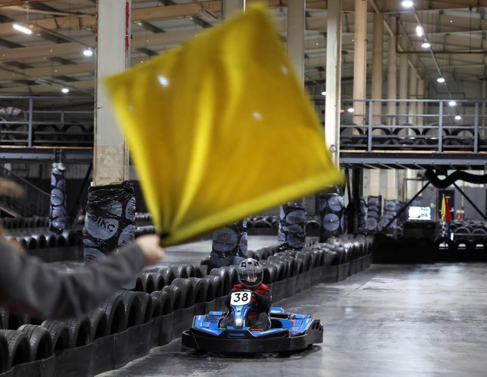 A girl drives under yellow flag conditions during a TeamSport girl only Go Karting taster session in Nottingham October 29, 2025. — AFP pic