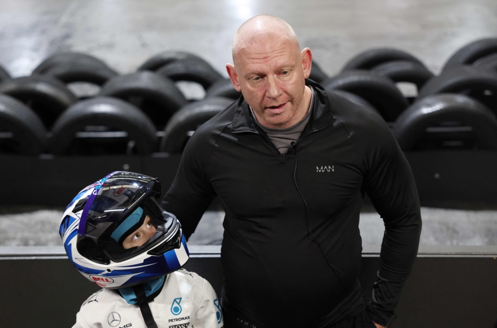 Georgia-Mai McKenzie, 8, and her father Marcus McKenzie speak after participating in a TeamSport Go Karting girl only taster session in Nottingham October 29, 2025. — AFP pic