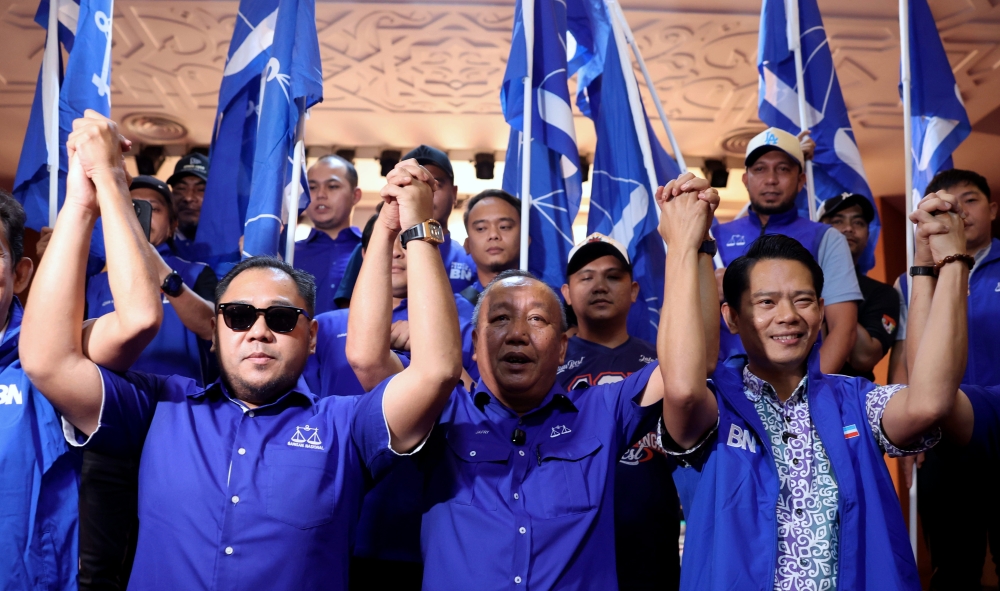 Barisan Nasional (BN) Sabah chairman Datuk Jafry Ariffin (centre) with BN candidates for the Lamag state by-election, Mohd Ismail Ayob, also known as Miha (right), and for the Kinabatangan parliamentary seat, Mohd Naim Kurniawan Moktar (left), during the candidate announcement at the UMNO Sabah office today. — Bernama pic