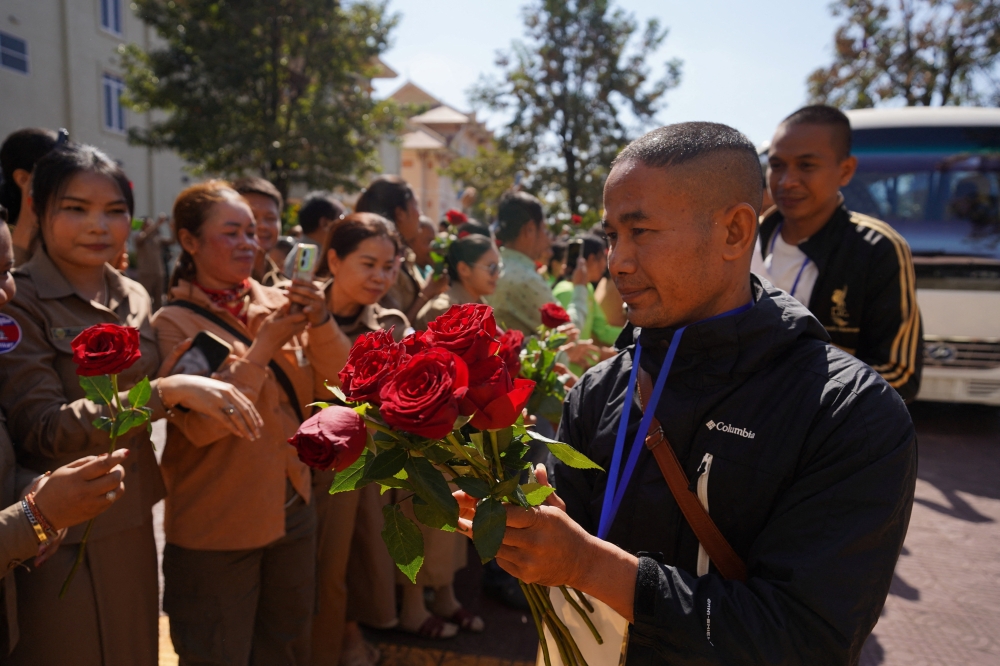 Cambodian soldiers repatriated from Thailand after being captured in July, receive roses from people following their release under the terms of a ceasefire agreement signed on December 27, 2025, in Pailin province, Cambodia, December 31, 2025. — Reuters pic