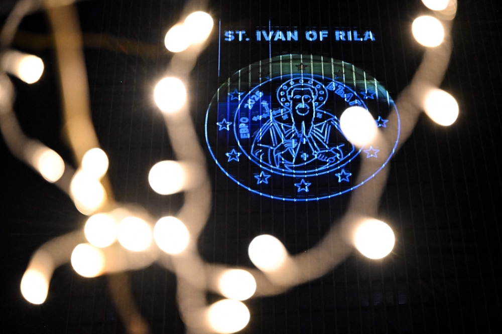 A projection of a Bulgarian Euro coin is pictured on the facade of the European Central Bank (ECB) headquarters in Frankfurt am Main December 30, 2025 as a preview of the ECB main building illumination in celebration of Bulgaria’s accession to the euro area. — AFP pic