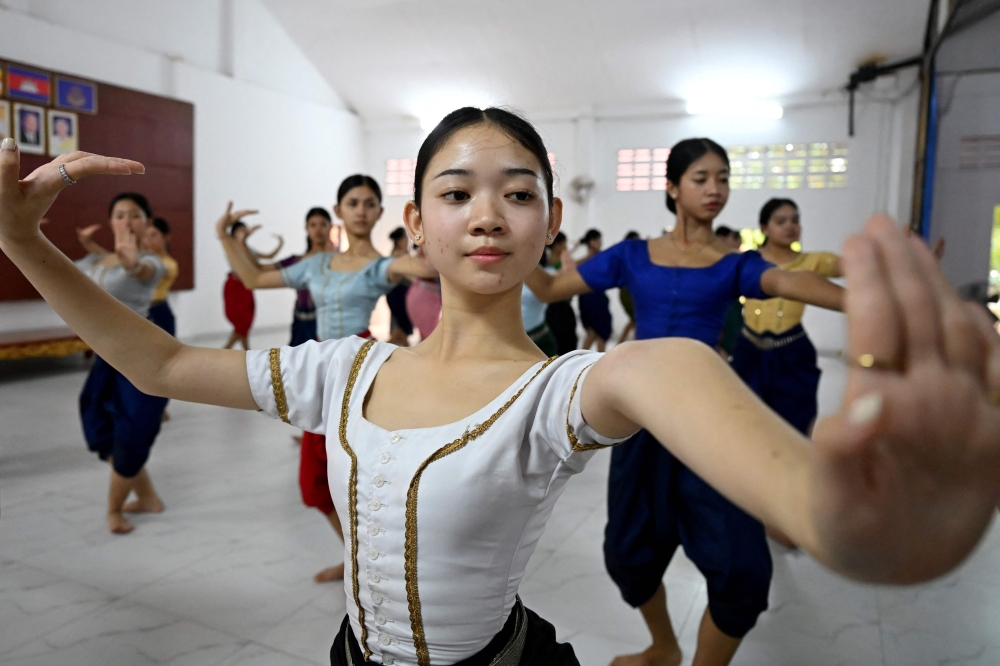 This photo taken on December 2, 2025 shows dance student Tola Thina, 18, practising with other students at the Secondary School of Fine Arts in Phnom Penh. — AFP pic 