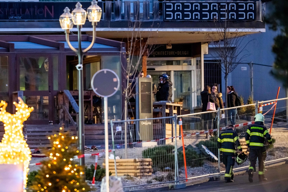 Authorities at the site of an explosion that ripped through a bar in Crans Montana January 1, 2026.  — AFP pic
