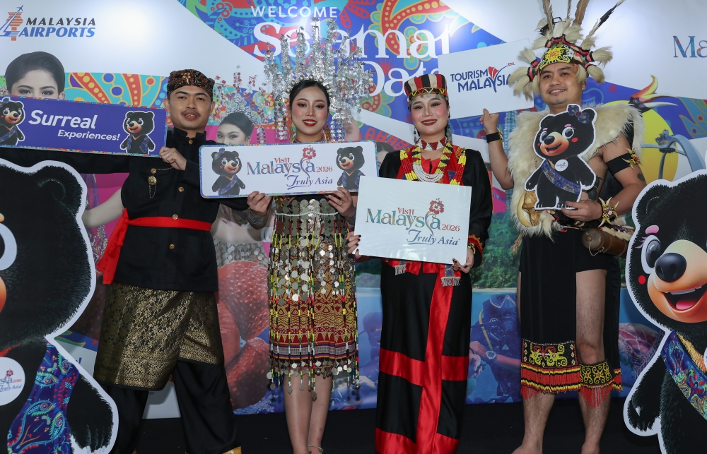 Tourists from abroad take the opportunity to pose for photos with the Visit Malaysia Year 2026 (VM2026) mascots Wira and Manja at the Sultan Abdul Aziz Shah Airport in Kuching January 1, 2026. — Bernama pic
