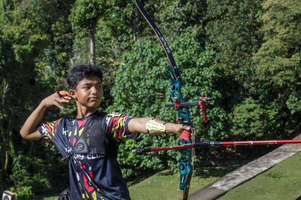 A participant aims with bow and arrow during the National Field Archery Championship at Panorama Bukit Antarabangsa, Hulu Kelang, Ampang December 20, 2025. — Picture by Raymond Manuel