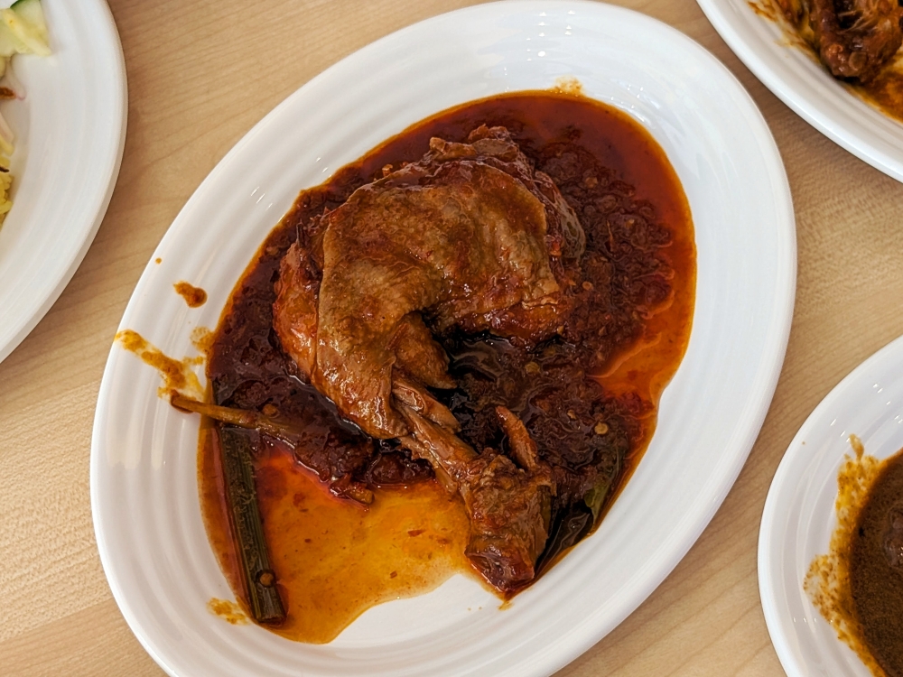 ‘Ayam Tanjung’ is a slightly spicier preparation that uses more chillies instead of the sweet fried onions that define ‘ayam bawang’. — Picture by Ethan Lau