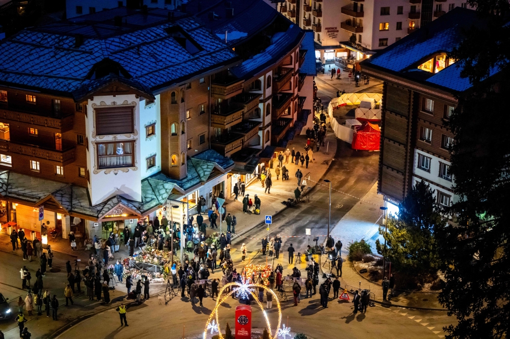 Mourners gather at makeshift memorials near the site of a fire that ripped through a bar during New Year's Eve celebrations in the Alpine ski resort town of Crans-Montana killing around 40 people and injuring more than 100 others, in Crans-Montana on January 2, 2026. — AFP pic 