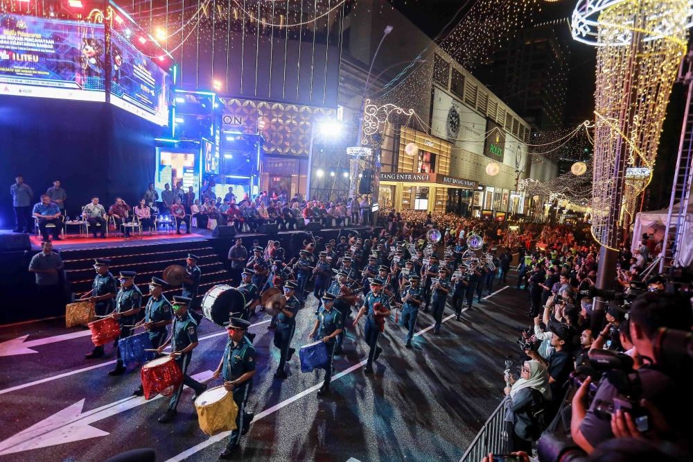 Prime Minister Datuk Seri Anwar Ibrahim, accompanied by VIPs, looks on as a marching band perform during the launch of the Lighting Innovation Project Towards Urban Sustainability at Pavilion Kuala Lumpur January 3, 2026. — Picture by Sayuti Zainudin