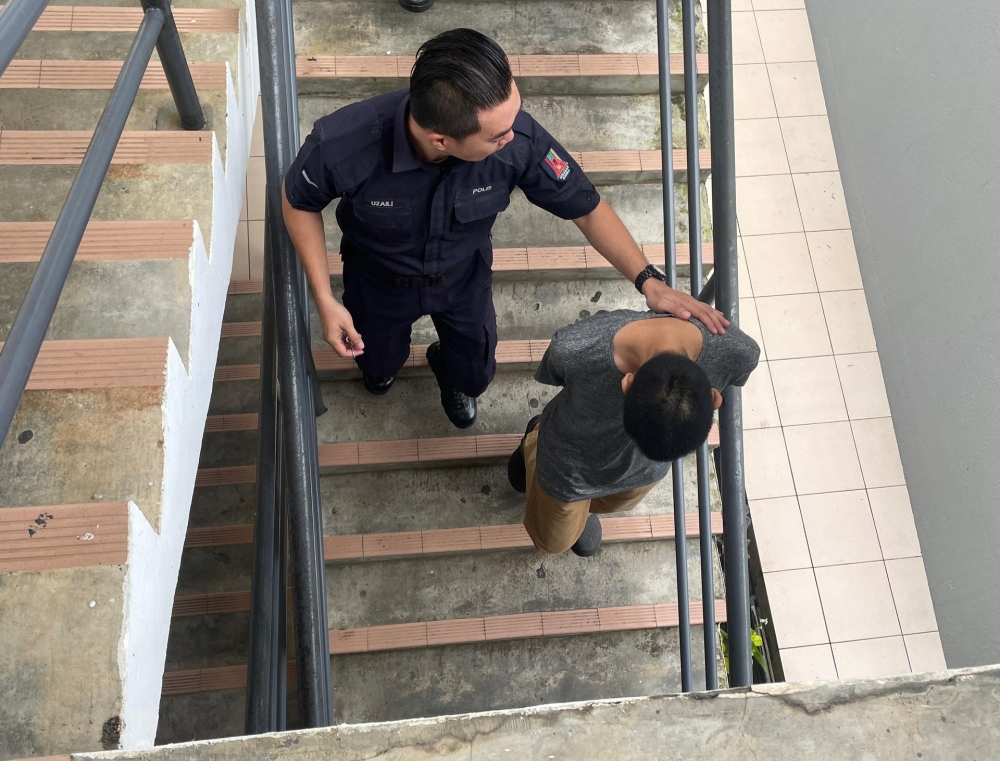 Christopher Brian Michael is led away after sentencing. Medical reports showed the father suffered minor injuries, while the sister sustained a deep head wound and multiple abrasions. — The Borneo Post pic