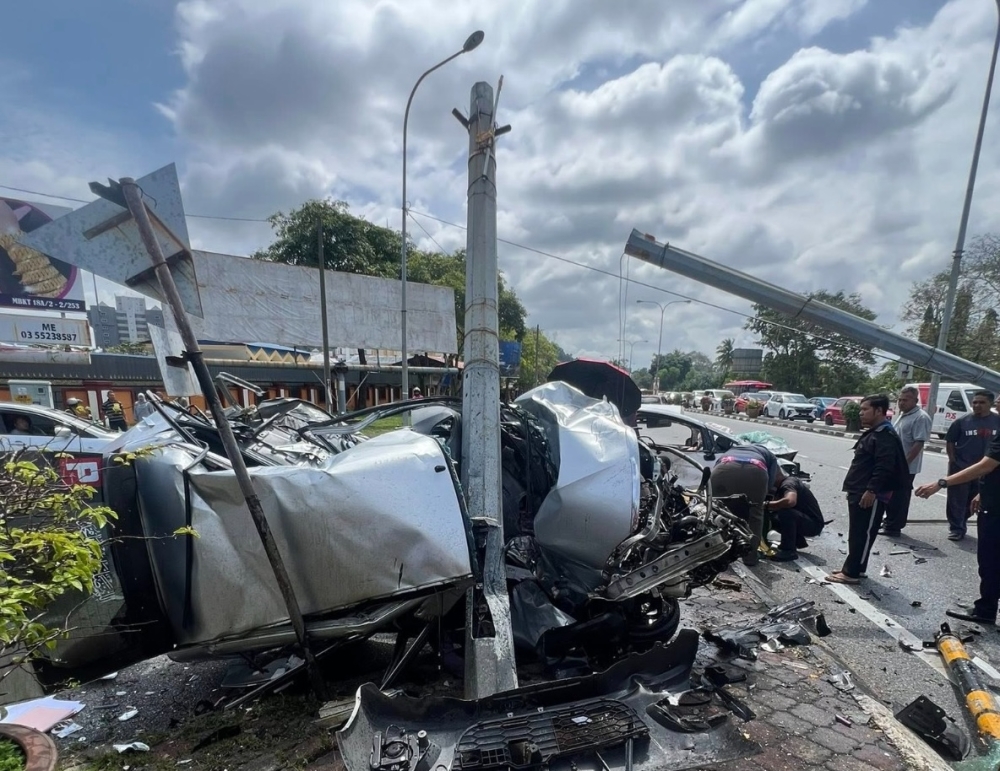 The aftermath of a violent collision at a Kuala Terengganu junction after a car ran a red light and struck a U-turning vehicle. — Picture via Facebook