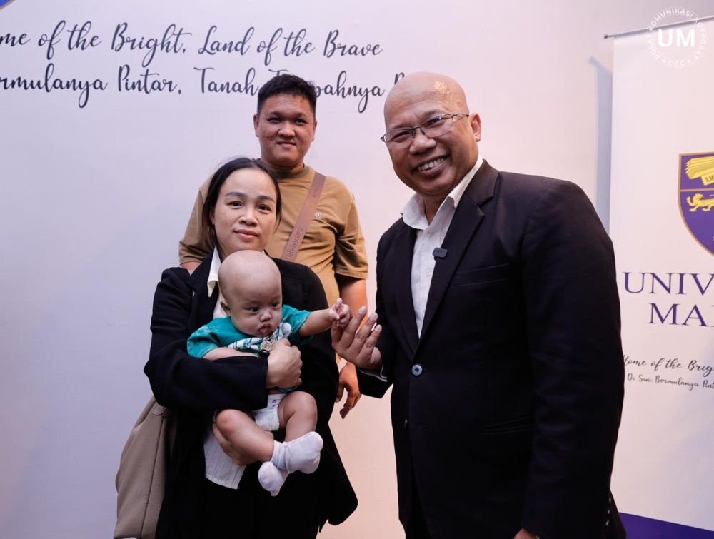Universiti Malaya vice-chancellor Noor Azuan Abu Osman with the four-month-old baby who underwent a historic liver transplant at the University of Malaya Medical Centre (UMMC), alongside members of the child’s family. — Picture via Facebook/Vice-Chancellor of Universiti Malaya