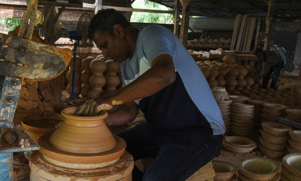 Passing down tradition, Reguraj welcomes young apprentices into his workshop to learn the centuries-old craft of clay pot-making. — Bernama pic