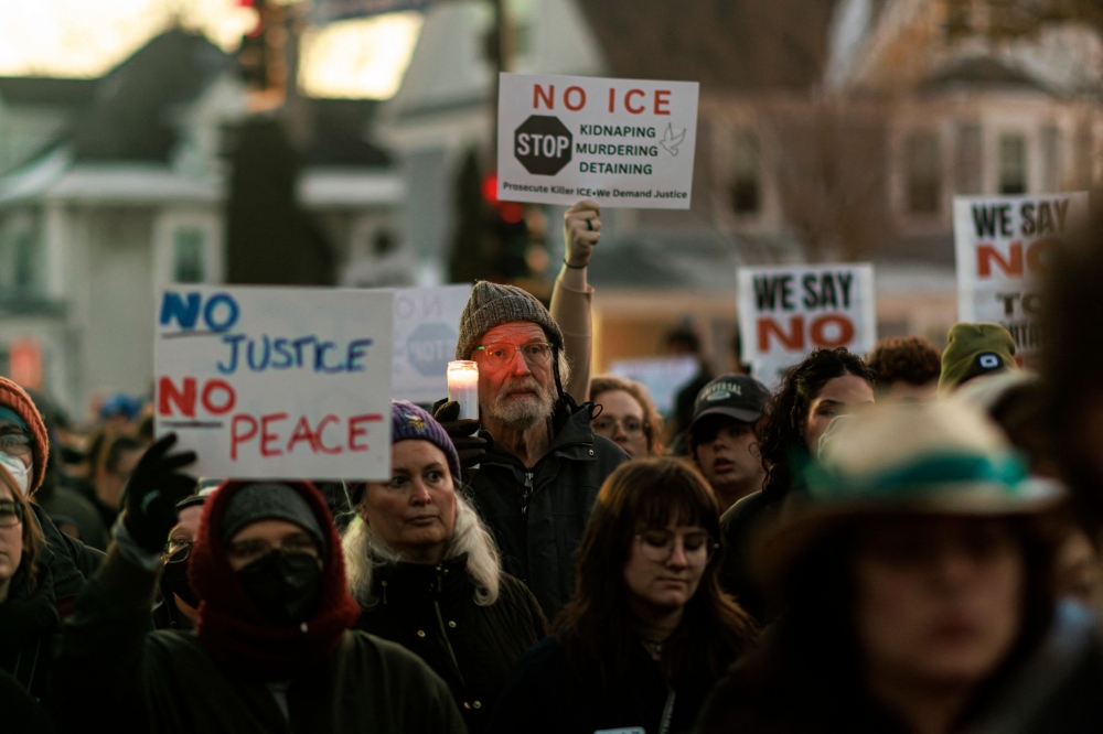 People demonstrate against ICE during a vigil honoring Renee Nicole Good. — AFP pic 