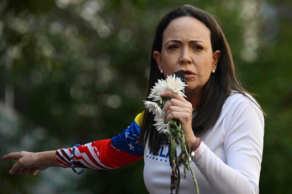 Venezuelan opposition leader Maria Corina Machado addresses supporters during a protest called by the opposition on the eve of the presidential inauguration, in Caracas on January 9, 2025. — AFP pic 