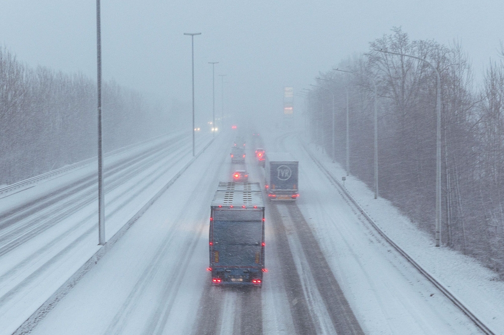 This photograph shows vehicles on a snow covered road near De Pinte in Belgium on January 7, 2026. Fierce winds battered France and Britain on Friday as storms barrelled through northern Europe, snarling train travel, shutting schools and cutting power to hundreds of thousands of homes in plunging winter temperatures. — AFP pic 