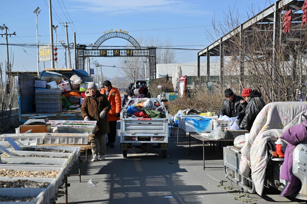 People in winter clothes visit a traditional market in Baoding, northern China’s Hebei province on January 7, 2026. — AFP pic