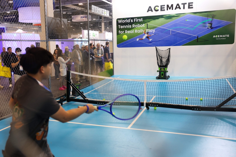 An attendee plays tennis with the Acemate tennis robot during the annual Consumer Electronics Show (CES) in Las Vegas, Nevada on January 7, 2026. — AFP pic 