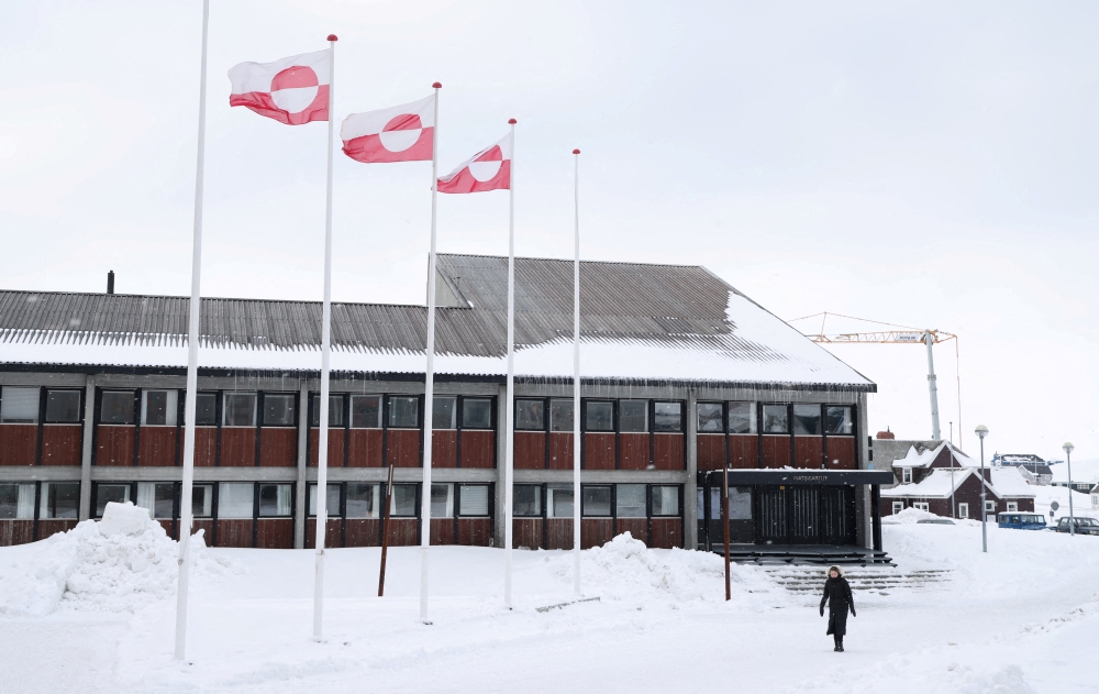A woman walks past Greenland's parliament Inatsisartut in Nuuk, Greenland, March 28, 2025. — Reuters pic