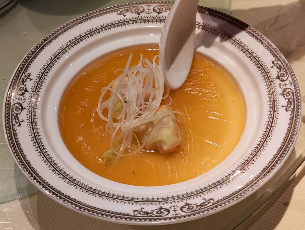 The Steamed Egg Custard with Cabbage & Prawn Paste is covered in a layer of chicken broth that’s so rich it forms a film of oil within minutes. — Picture by Ethan Lau