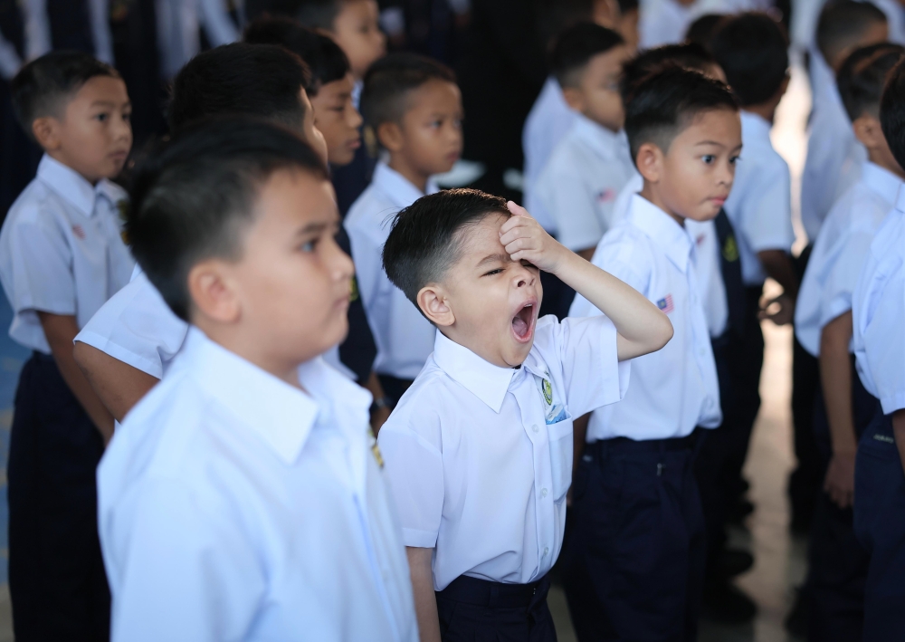 From sleepy yawns to bright smiles, Malaysia’s children return to classrooms