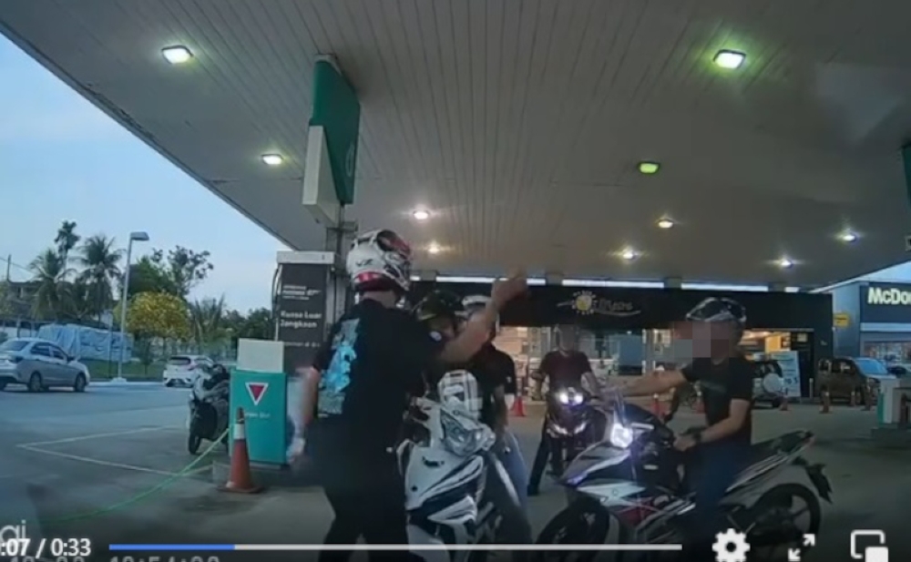 The 33-second video shows a male motorcyclist, who was carrying a woman pillion rider, being slapped by a man alleged to be a policeman at a petrol station in Taman Perling. — Screengrab from social media 
