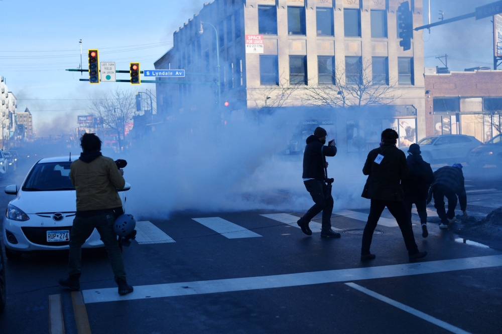 US Customs and Border Protection agents disperse tear gas during a patrol while looking to detain undocumented persons during immigration enforcement activity in Minneapolis, Minnesota, on January 12, 2026. — AFP