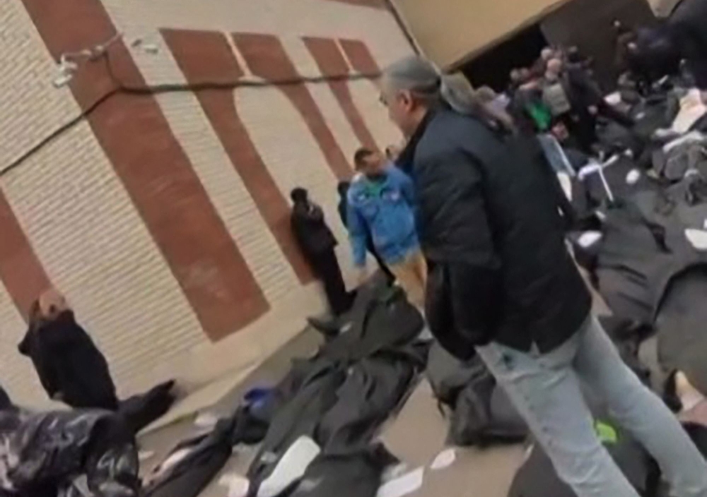 This video grab taken from UGC images on January 12, 2026, and first appeared online on January 10, 2026, and verified by AFPTV teams in Paris on January 11, 2026, shows the courtyard of the Forensic Diagnostic and Laboratory Center of Tehran Province in Kahrizak with dozens of bodies in body bags laid out for family members. — AFP pic