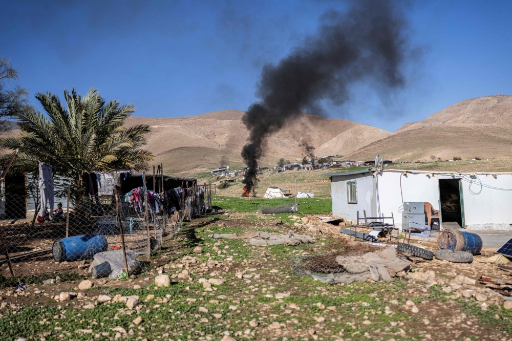 Garbage is burnt as Bedouin families begin to gather their belongings to leave their homes after continues harassment from Israeli right-wing settlers in Ras Ein al-Auja. — AFP pic 