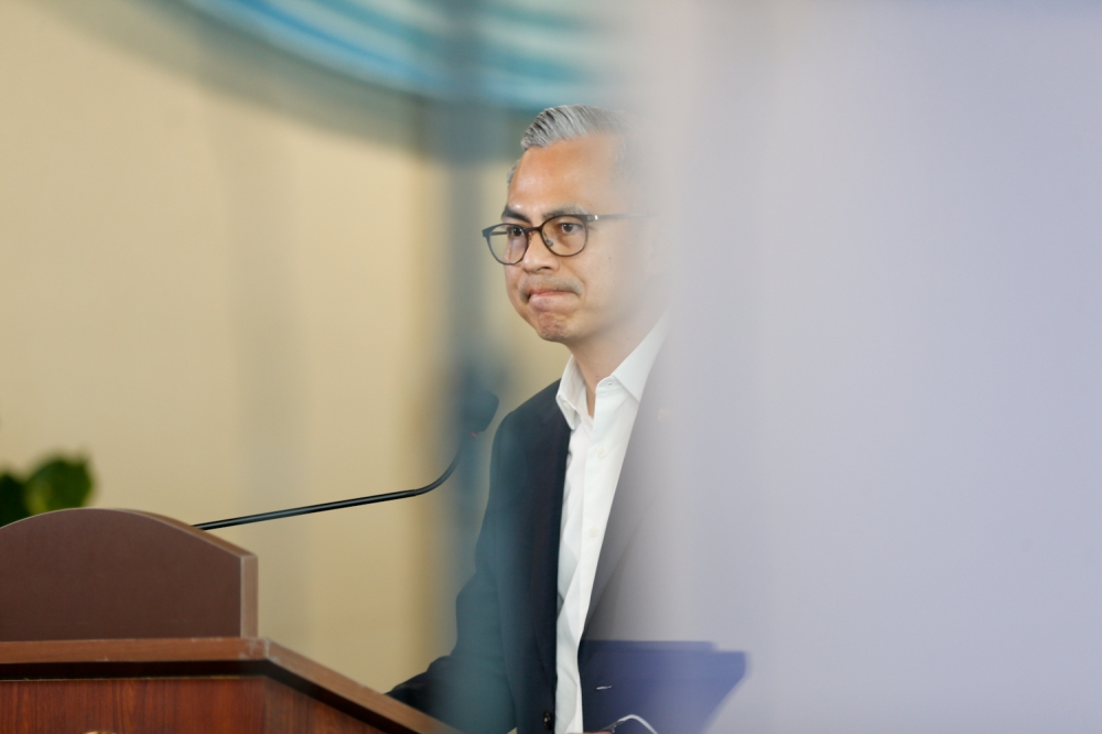 Communications Minister Datuk Fahmi Fadzil speaks to reporters after the weekly post-Cabinet meeting in Putrajaya January 14, 2026. — Picture by Raymond Manuel