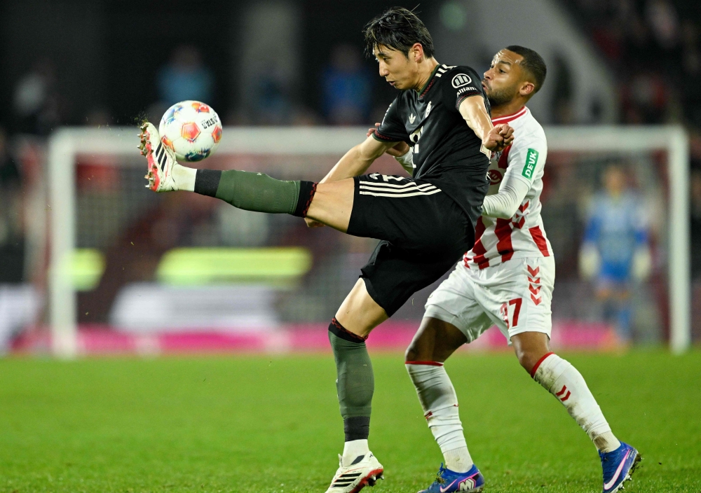 Bayern Munich’s Japanese defender #21 Hiroki Ito (L) and FC Cologne’s German midfielder #37 Linton Maina vie for the ball during the German first division Bundesliga football match between FC Cologne and FC Bayern Munich in Cologne, western Germany on January 14, 2026. — AFP pic