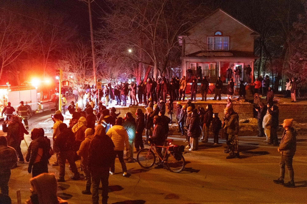 Residents confront federal agents following a shooting incident on January 14, 2026 in Minneapolis, Minnesota. — AFP pic