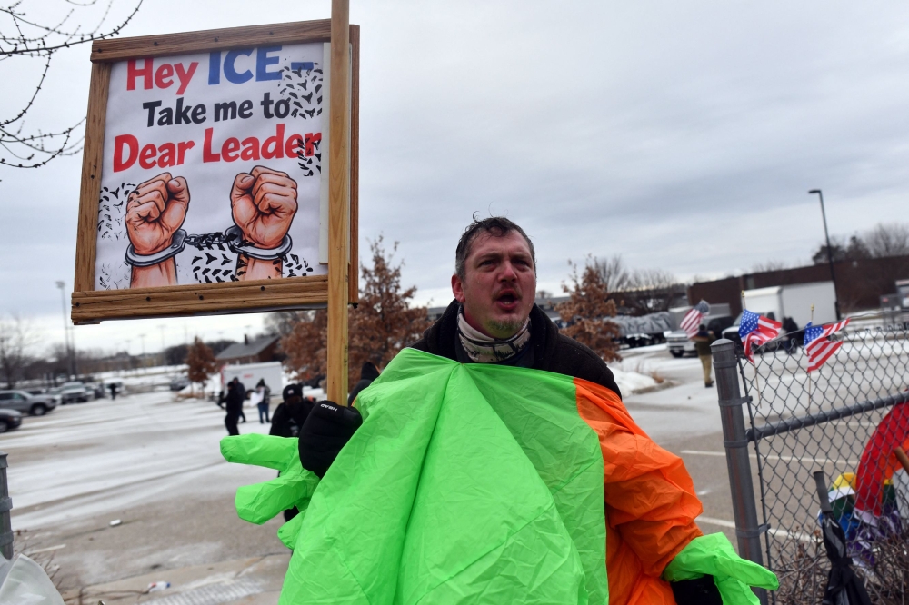 A protester holds a sign during a demonstration against ICE outside the Bishop Whipple Federal Building in Minneapolis, Minnesota, on January 15, 2026. — AFP pic