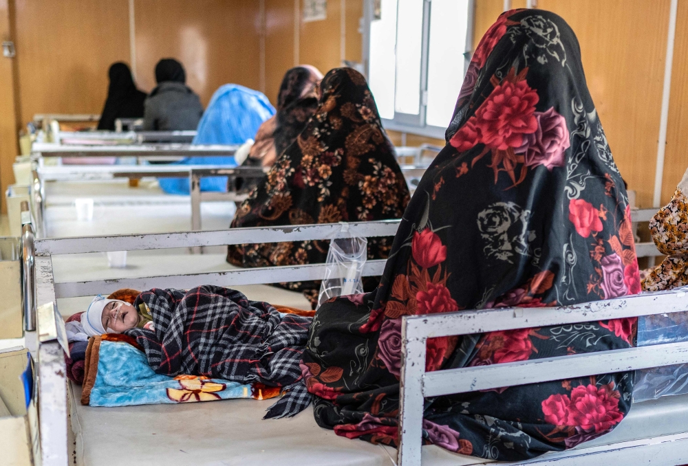 Afghan women with their malnourished children sitting inside the Medecins Sans Frontieres malnutrition ward at a hospital in Herat on January 8, 2026 shows  — AFP pic