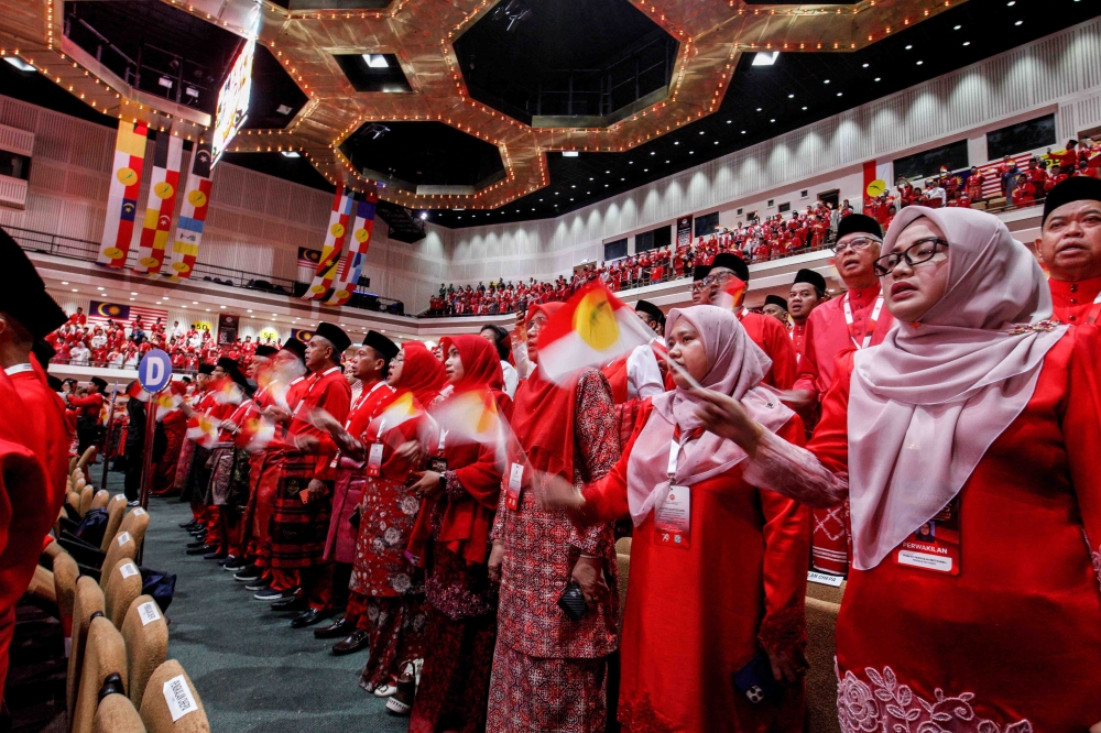 Umno members wave flags as party president Datuk Seri Ahmad Zahid Hamidi delivers his keynote address during the 2025 Umno General Assembly at the World Trade Centre on January 15, 2026. — Picture by Sayuti Zainudin