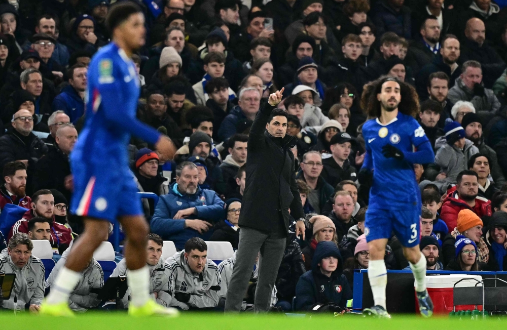 Arsenal’s Spanish manager Mikel Arteta (centre) reacts during the English League Cup semi-final first leg football match between Chelsea and Arsenal at Stamford Bridge, in London on January 14, 2026. — AFP pic