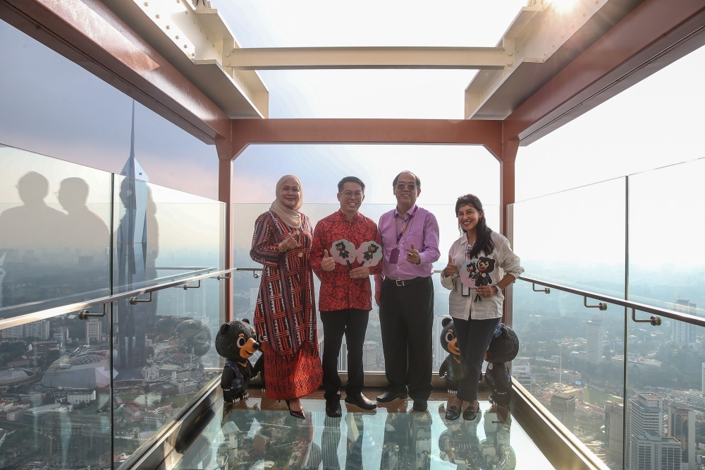 Tourism Malaysia deputy director-general, Lee Thai Hung (2nd left) and Tourism Malaysia director of the International Promotion Division, Baizuri Baharum (left) pose for group pictures during the ‘Explore Malaysia with Wira & Manja’ programme at KL Tower on January 16, 2026. — Picture by Yusof Isa
