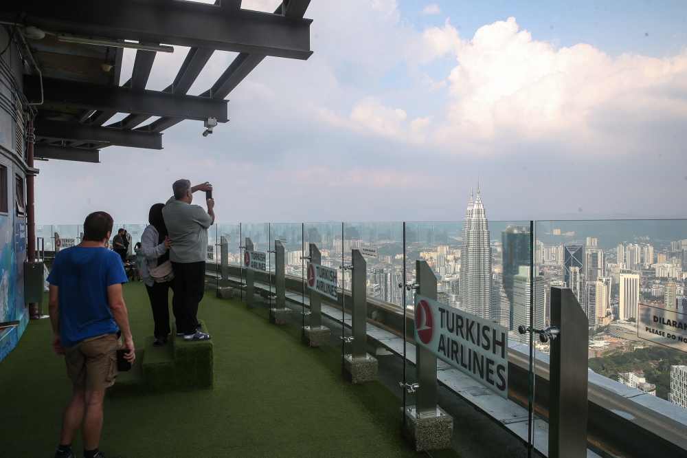 Tourists take pictures of the Kuala Lumpur skyline from KL Tower January 16, 2026. — Picture by Yusof Isa