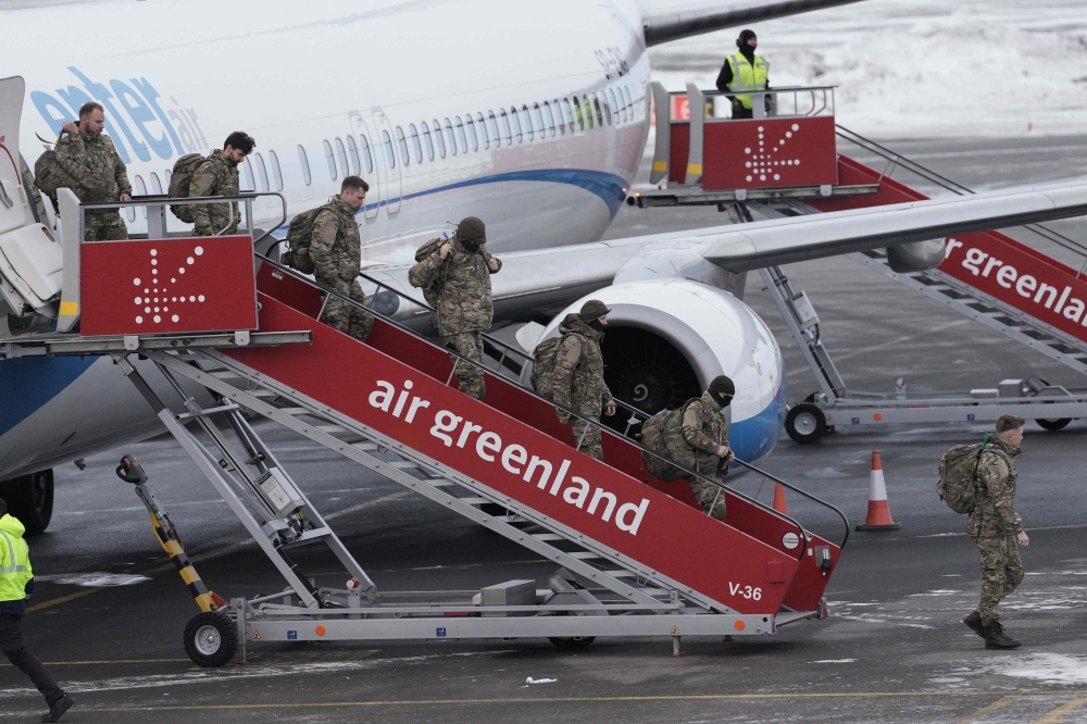 Military personnel believed to be from the German armed Forces Bundeswehr disembark a charter plane upon arrival at Nuuk international airport on January 16, 2026 in Nuuk, amid Trump’s insistence on taking mineral-rich Greenland. — AFP pic