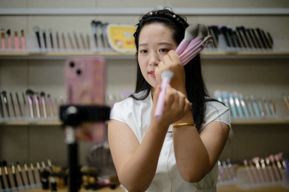 A livestream beauty host showcases makeup brushes at the studio of a Chinese cosmetics manufacturer, part of a new wave of C-Beauty brands gaining global attention. — AFP pic