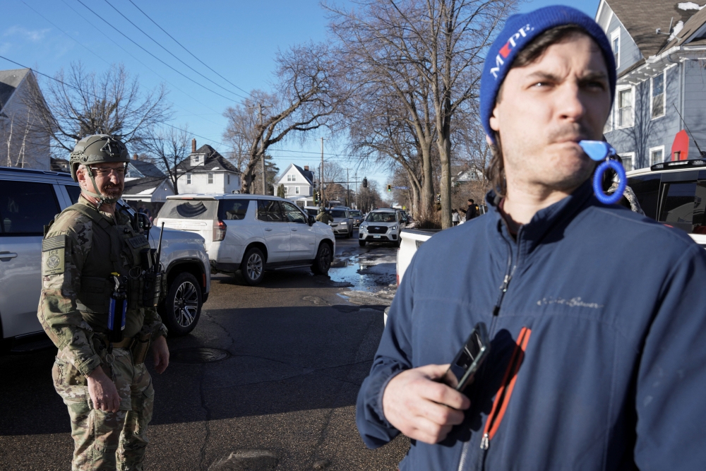 A man uses a whistle to alert people of the presence of federal agents in the area, days after an ICE agent fatally shot Renee Nicole Good, in Minneapolis, Minnesota January 13, 2026. — Reuters pic