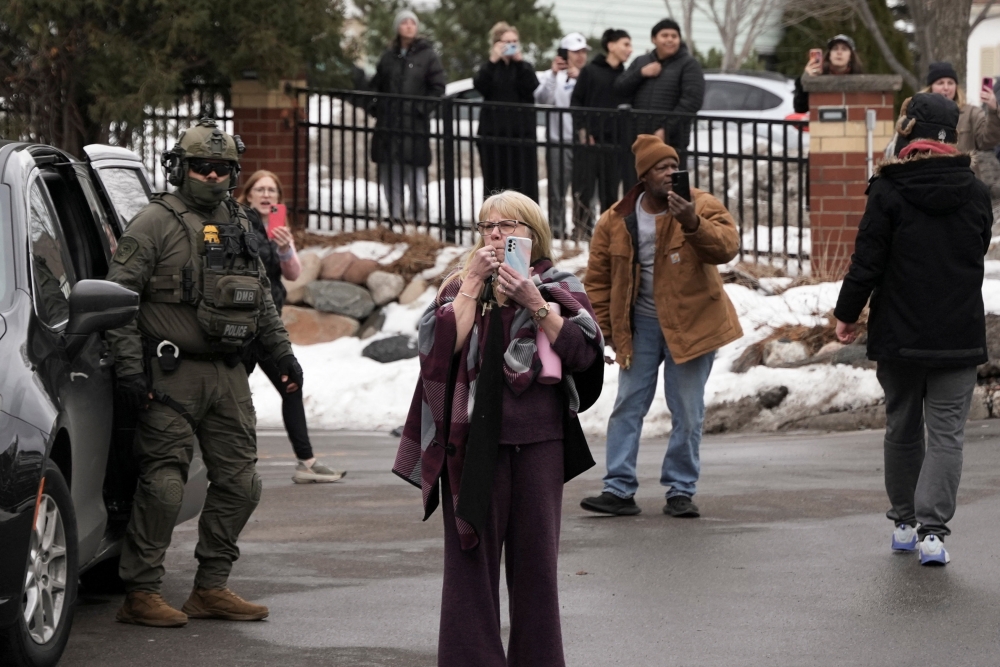 Observers use mobile phones to document, as one of them uses a whistle to alert people of the presence of Border Patrol commander Greg Bovino's convoy at a gas station, days after an ICE agent fatally shot Renee Nicole Good in Minneapolis, in Columbia Heights, Minnesota January 13, 2026. — Reuters pic
