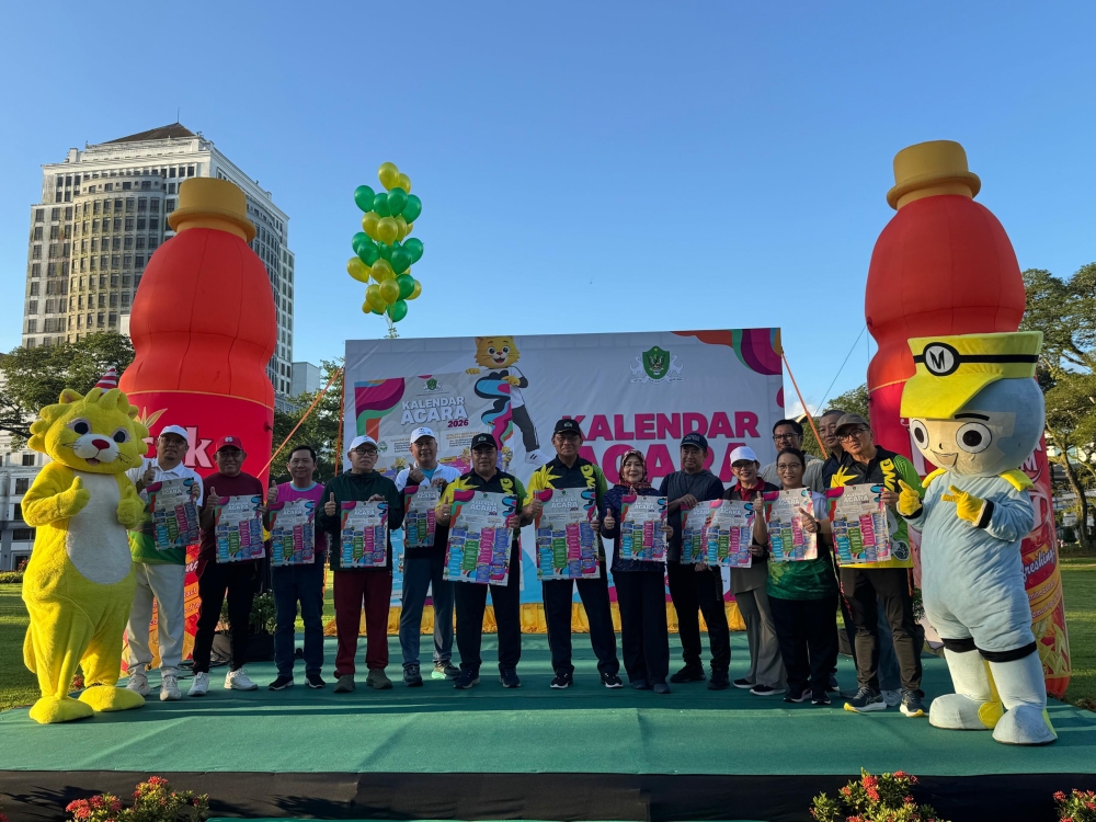 Dr Abdul Rahman (7th left) and Hilmy on his right in a photo call after launching the DBKU’s 2026 KCFM and Events Calendar at Padang Merdeka on Sunday. — The Borneo Post pic