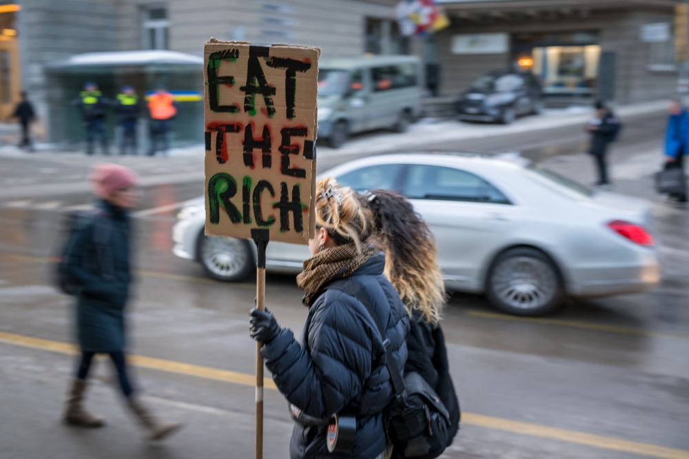 Protesters take part in a demonstration against the World Economic Forum on the eve of the WEF annual meeting in Davos, Switzerland on January 18, 2026. — AFP pic