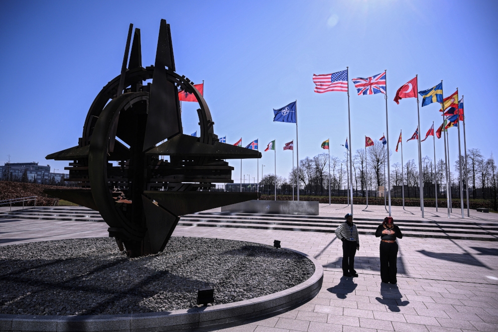 This photograph taken on March 6, 2025 shows the member nation flags including the US (centre) and British flags and the Nato Star sculpture, on display in the Cour d'Honneur of the The North Atlantic Treaty Organization (Nato) headquarters, in Brussels. — AFP pic