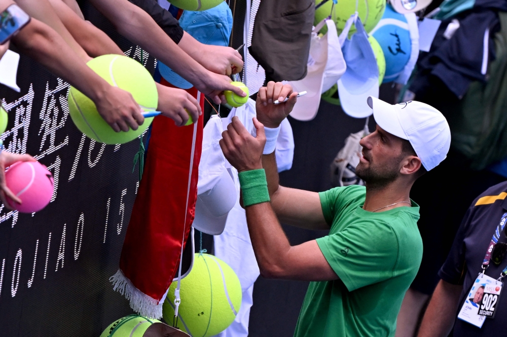 Novak Djokovic of Serbia signs autographs after a practice session in Melbourne on January 15, 2026, ahead of the Australian Open tennis tournament starting on January 18. — AFP pic