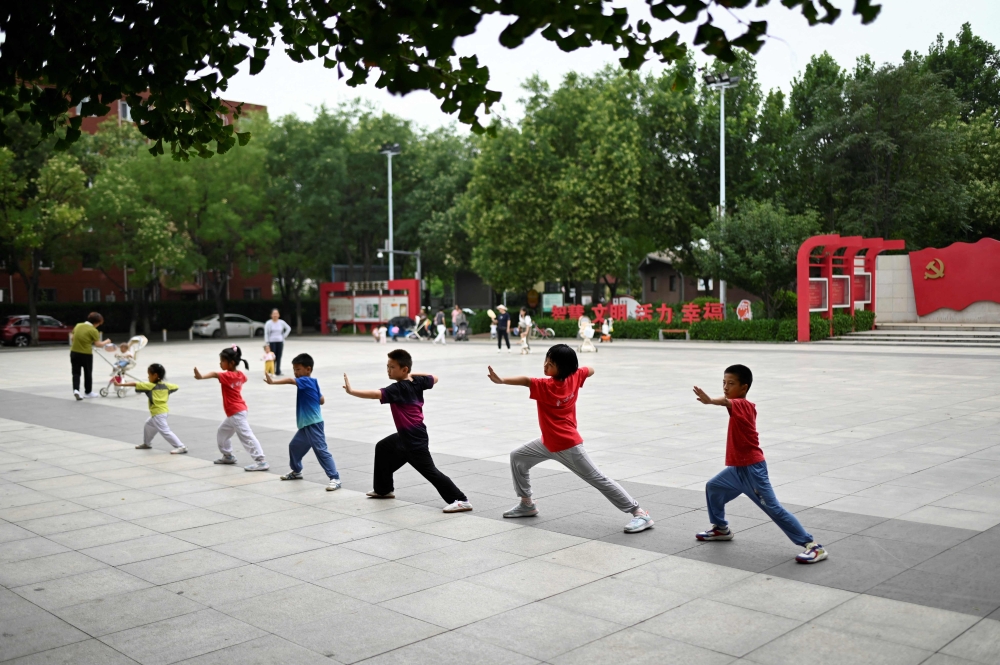 A group of children practise Chinese martial arts at a square in Beijing on July 16, 2025. China’s birth rate fell last year to its lowest level on record, official data showed on January 19, 2026, as its population shrank for a fourth year running despite authorities’ efforts to curb the decline. — AFP pic