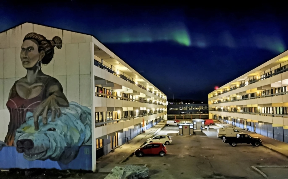 The Aurora Borealis (Northern Lights) is seen behind a building with social housings with a mural in Nuuk, Greenland. — Reuters file pic 